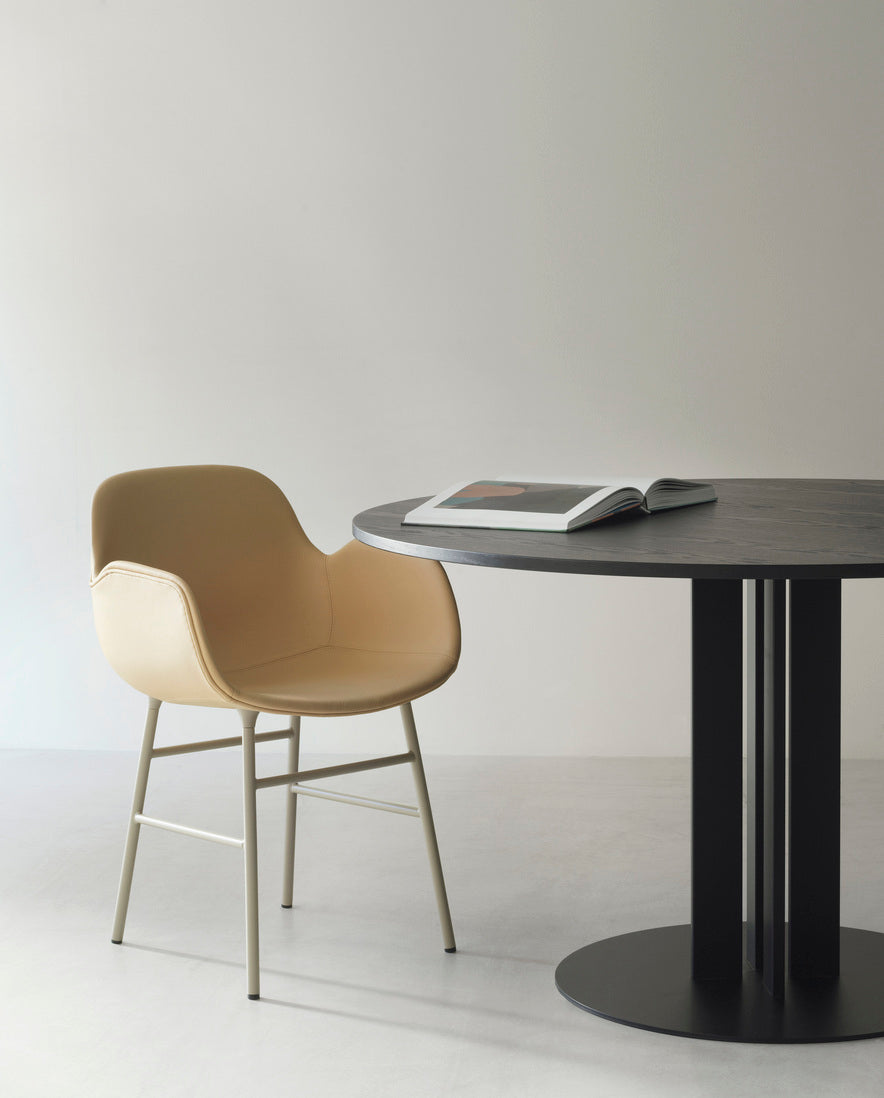 Upholstered chair with armrests of forms with a brown base