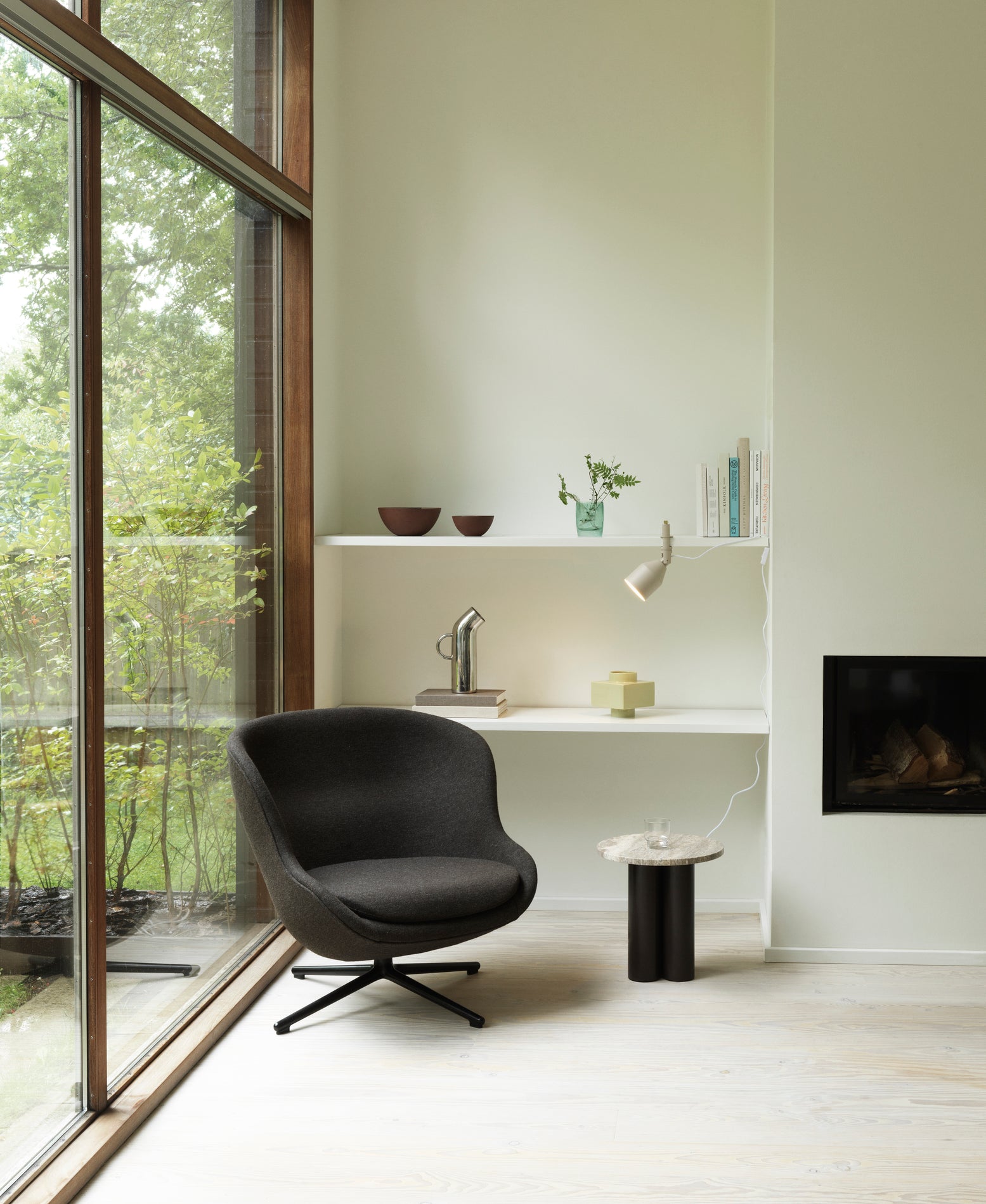 Hyg Low upholstered armchair with a black base