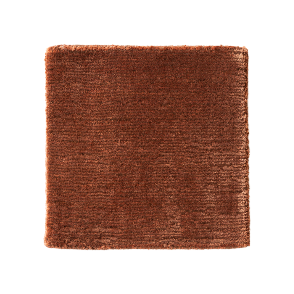 GUBI rug in rusty red with long pile
