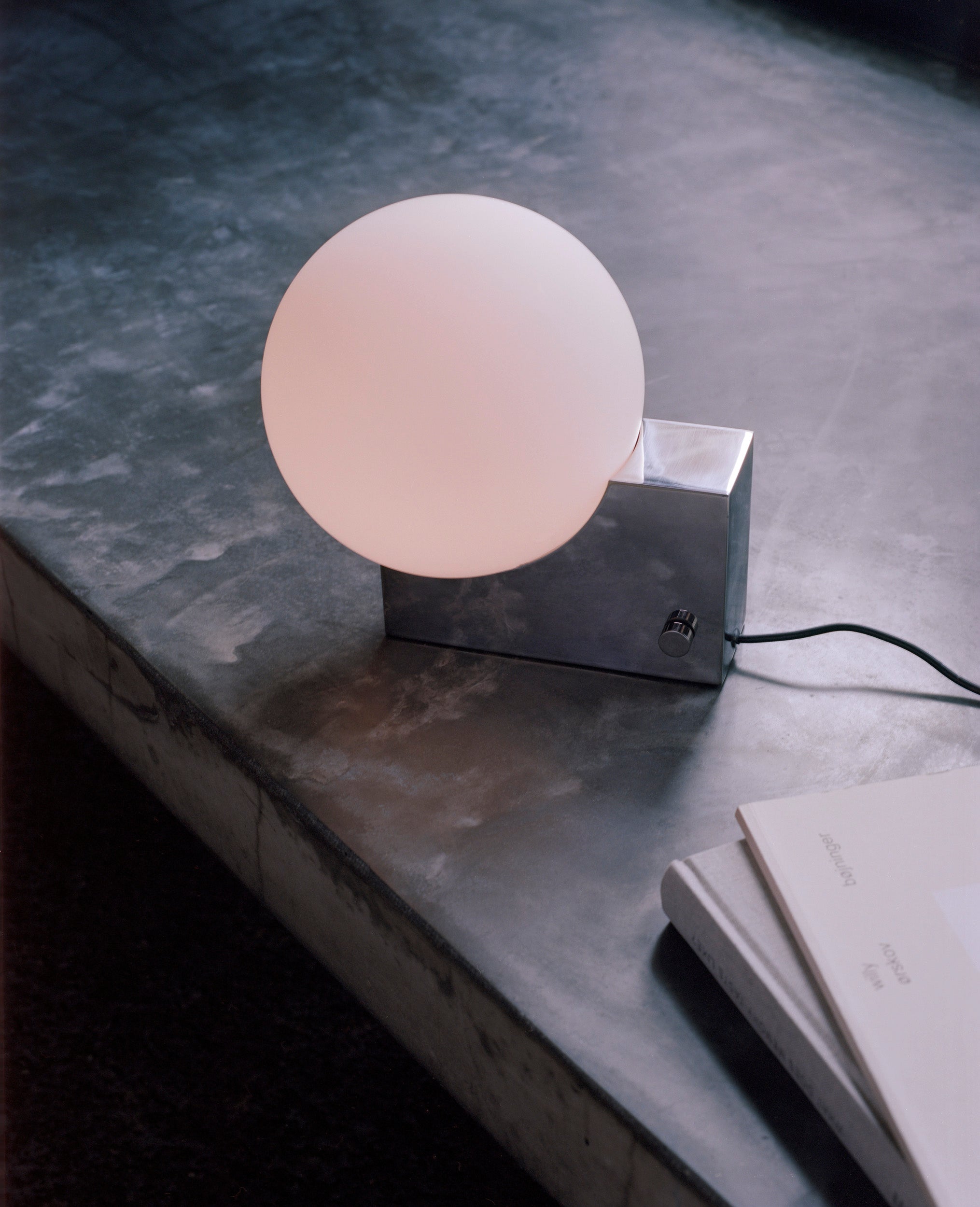 Stolní lampa JOURNEY SH1 s mléčným stínidlem a šedým podstavcem.