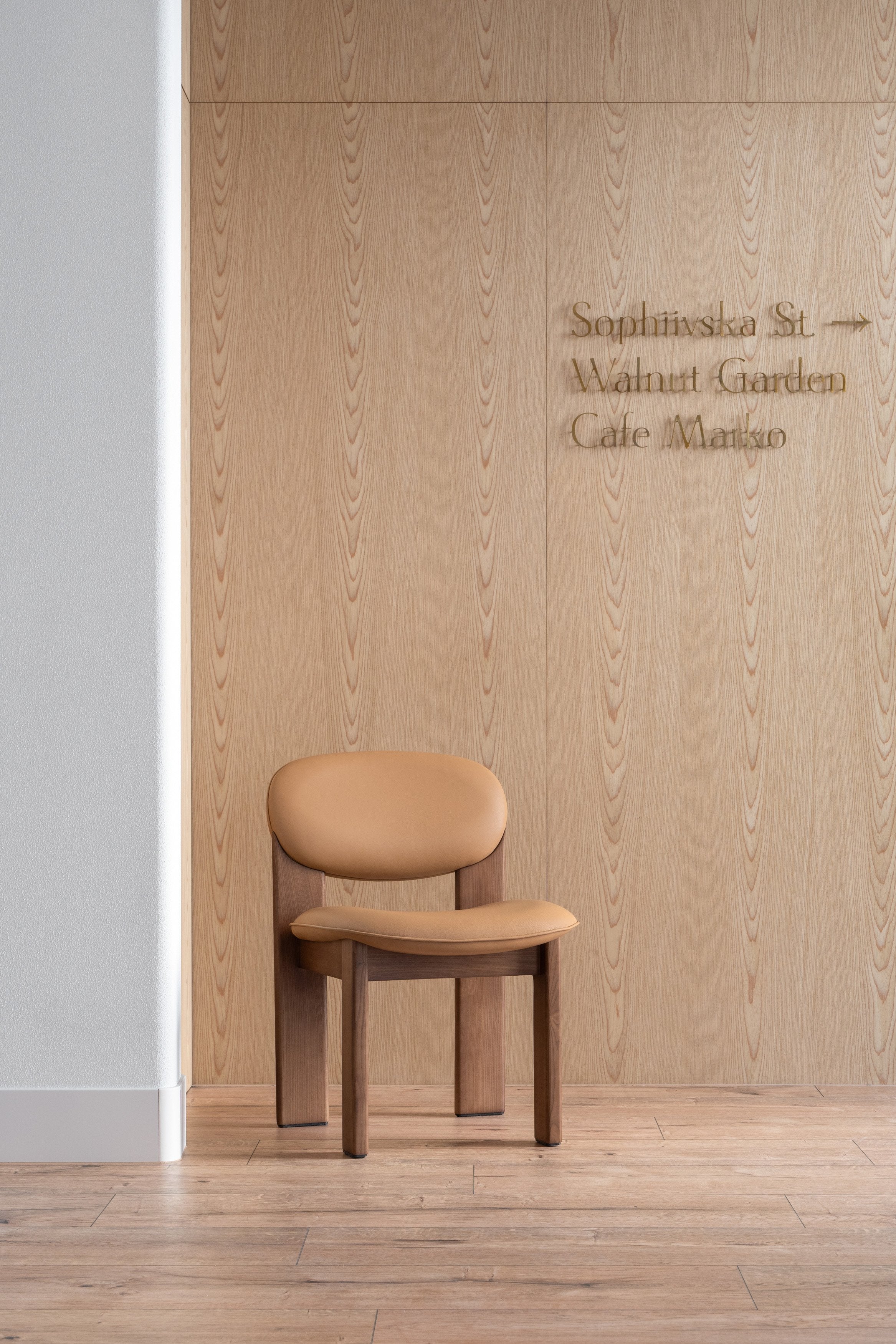 ARCHIPEN upholstered chair with a brown ash base