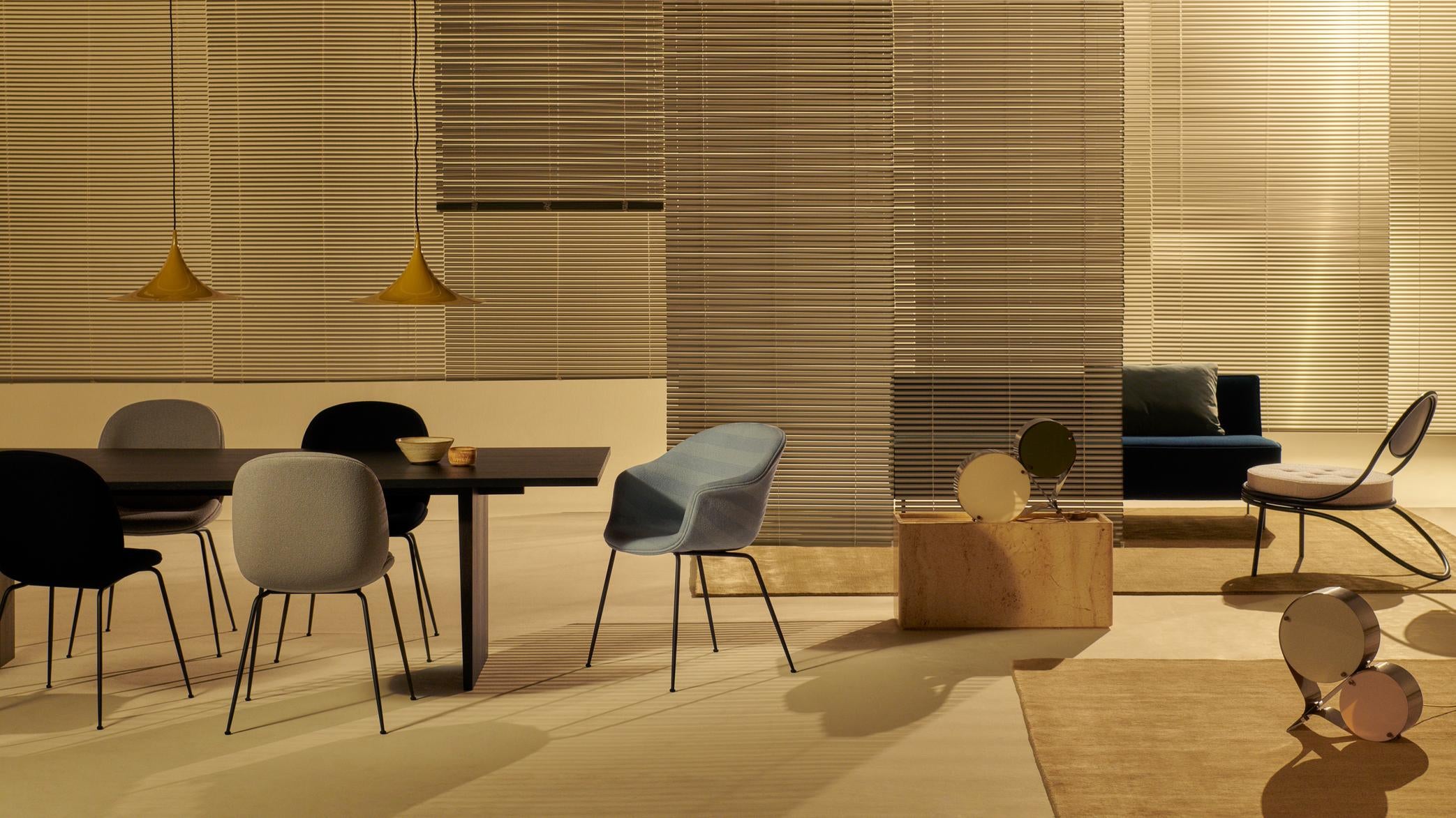 Čalouněné křeslo BAT s mosazným podstavcem