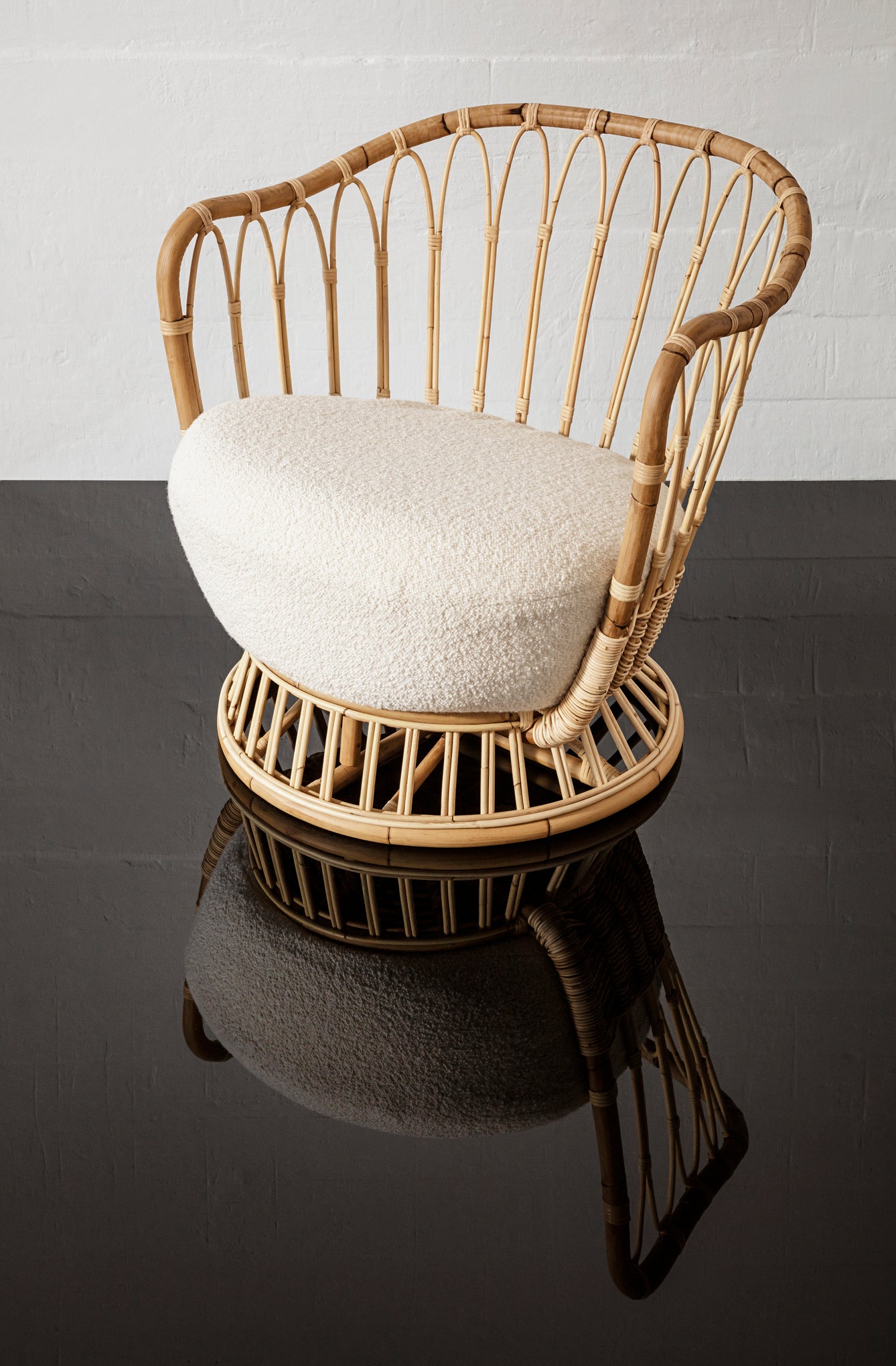 GRACE upholstered armchair with a rattan base