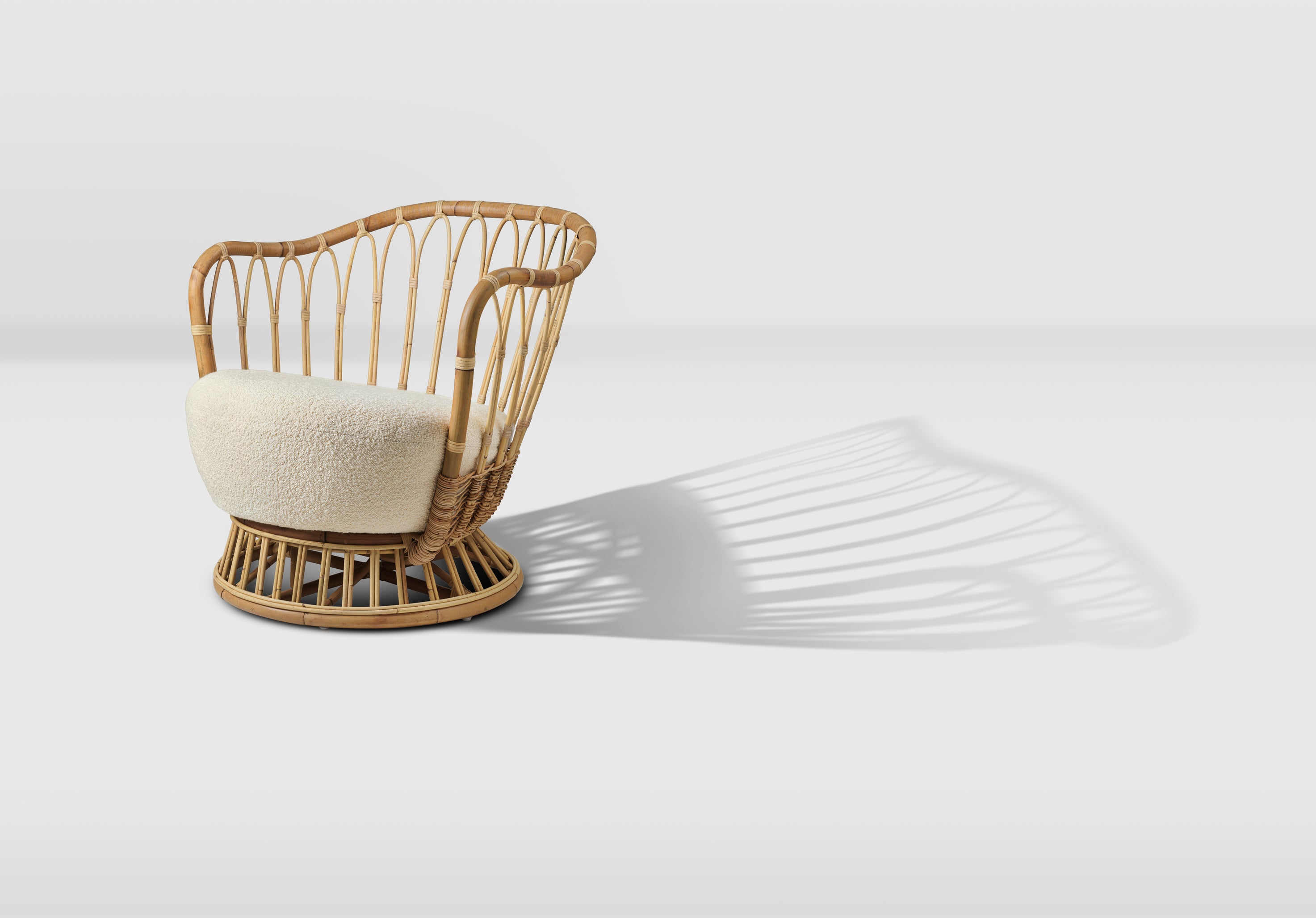 GRACE upholstered armchair with a rattan base