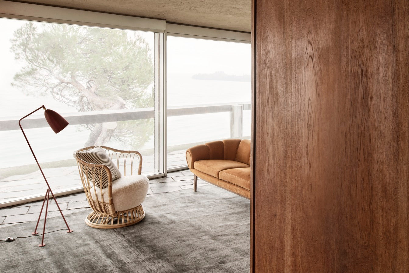 GRACE upholstered armchair with a rattan base