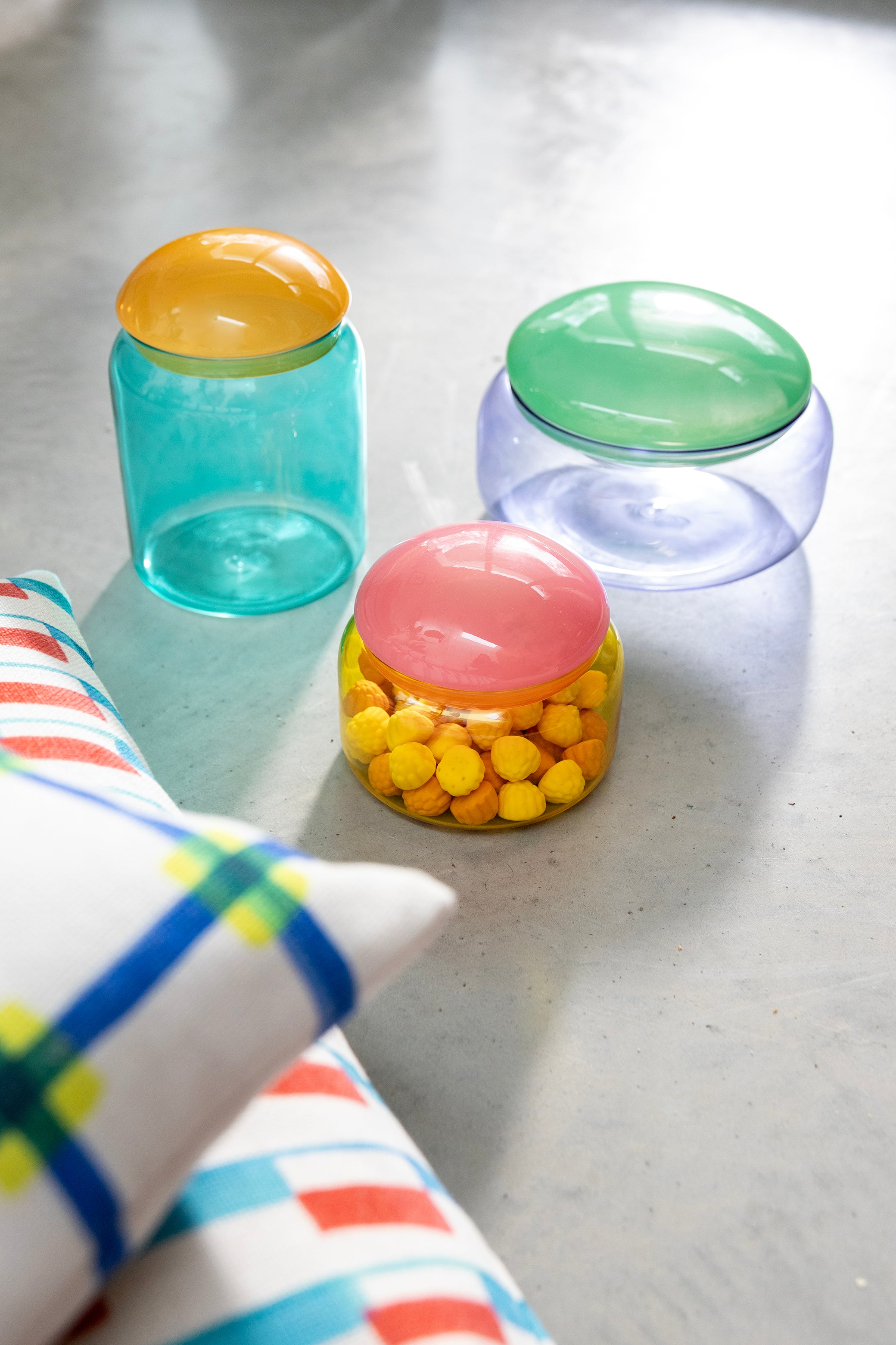 Turquoise glass container PUFFY with an orange lid