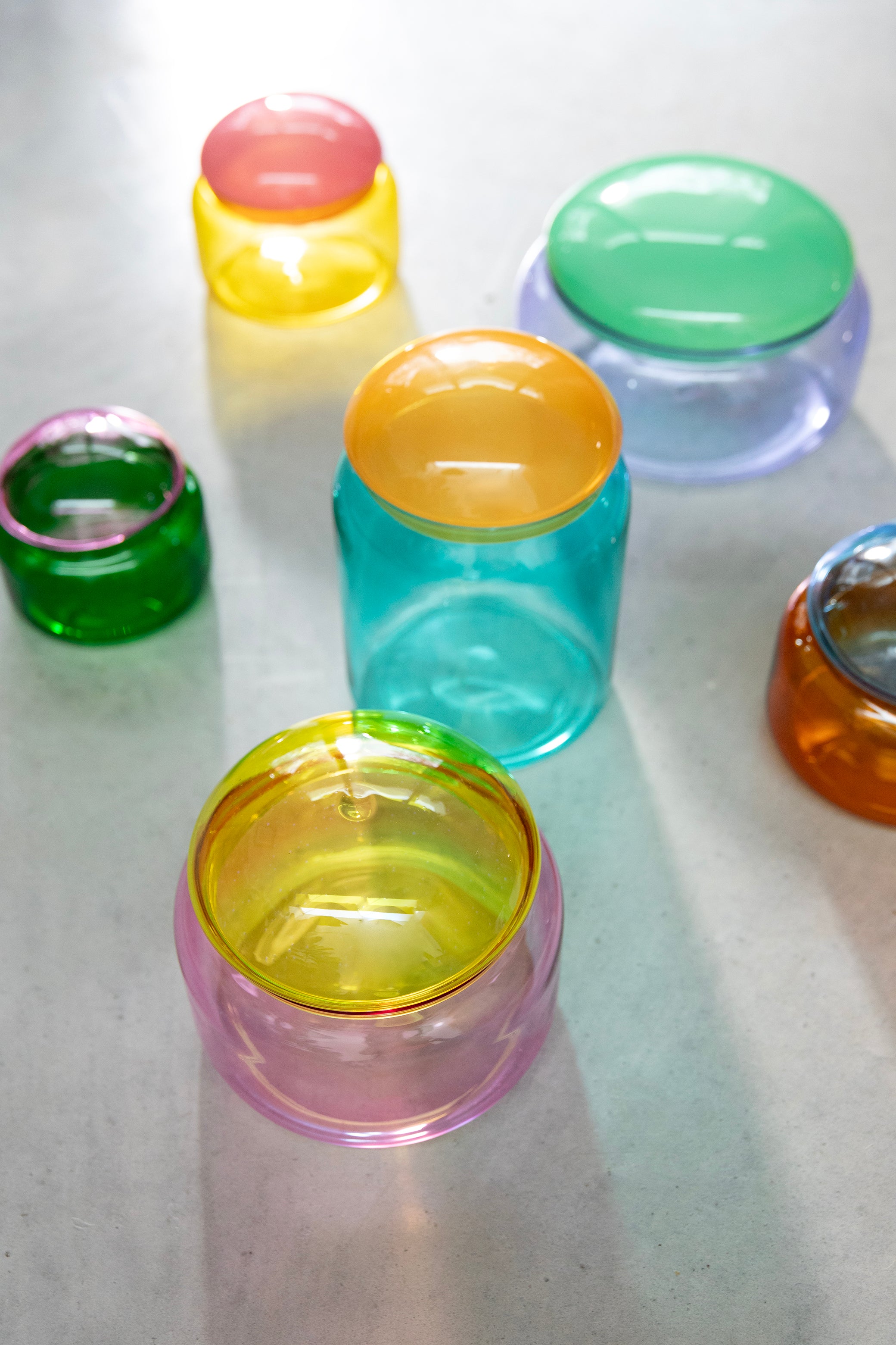 Turquoise glass container PUFFY with an orange lid