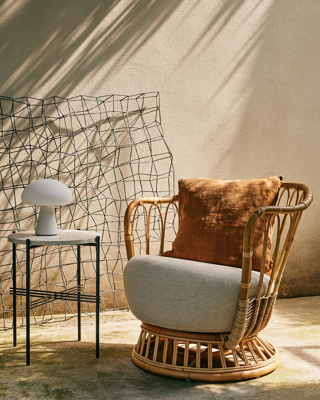 GRACE upholstered armchair with a rattan base