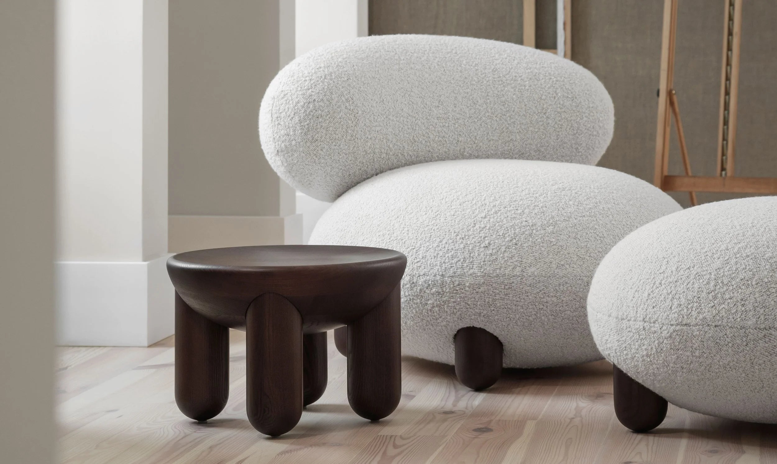 Upholstered pouf with wooden base