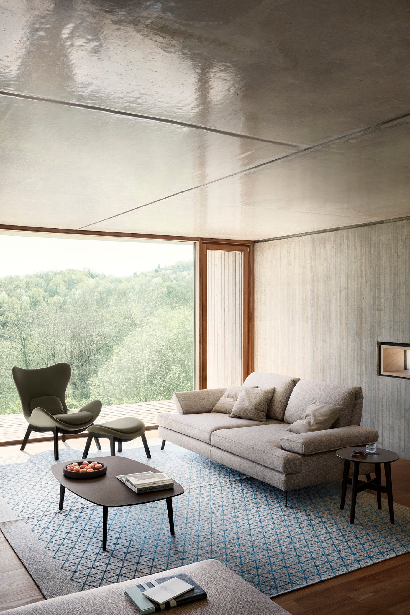 Upholstered LAZY armchair with a dark wooden base