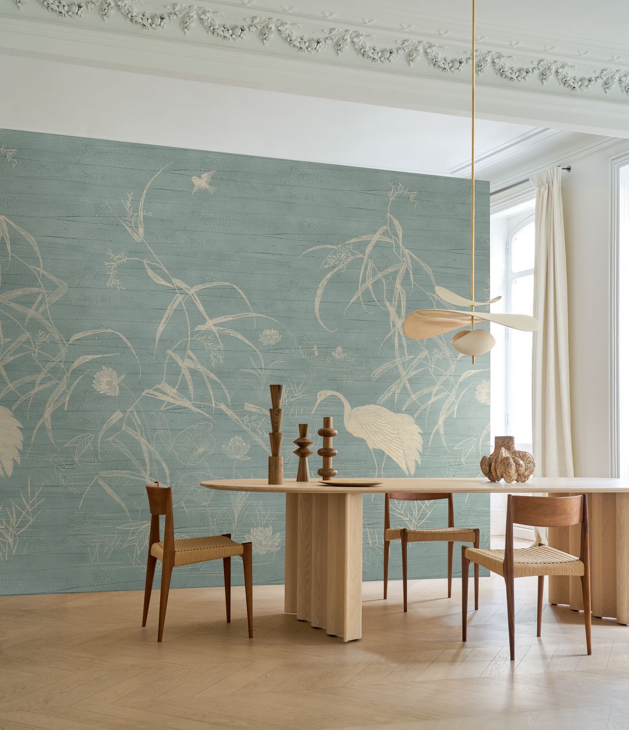 Mint green mural with a plant and bird motif by NUIDO with beige