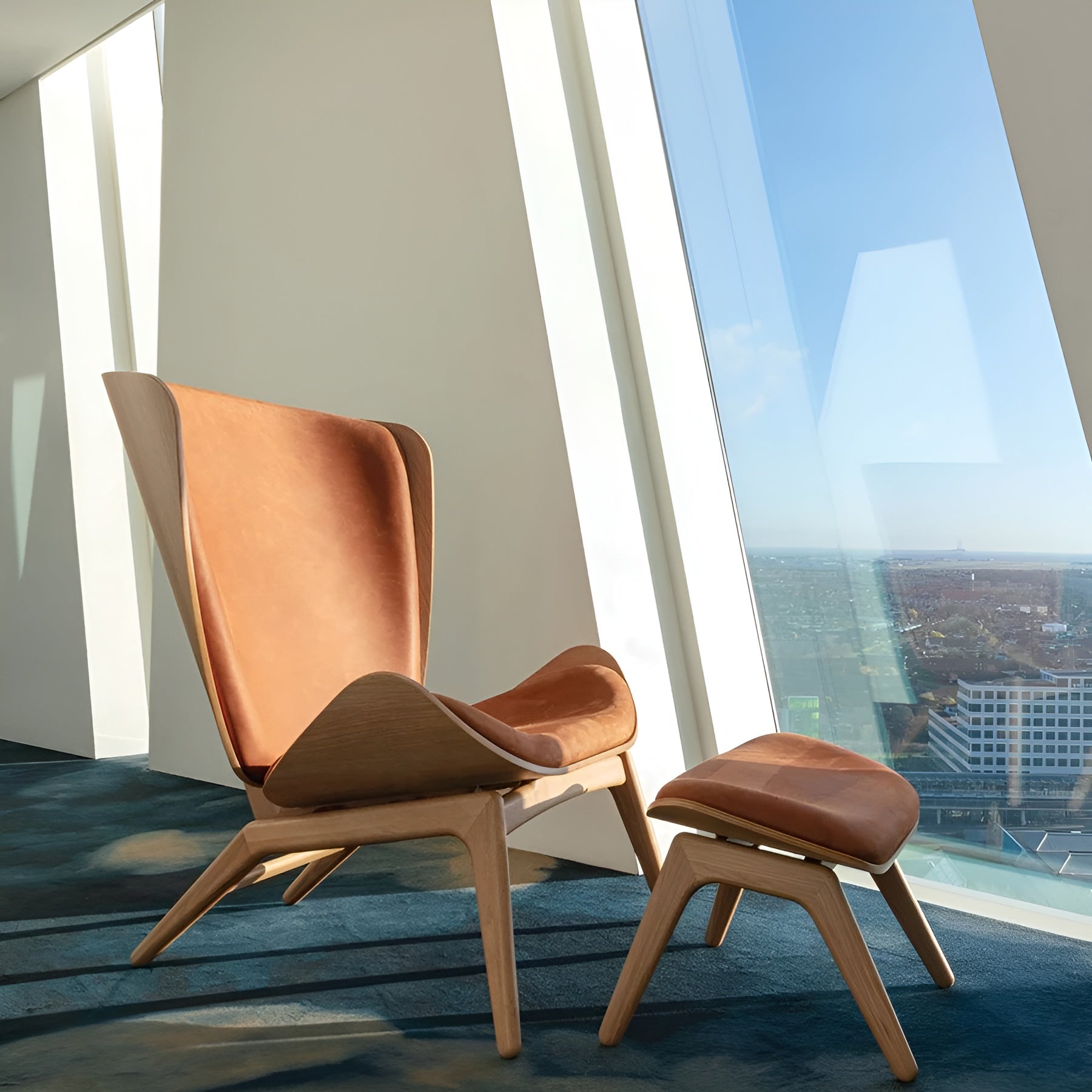 READER armchair in cognac leather with a dark oak base