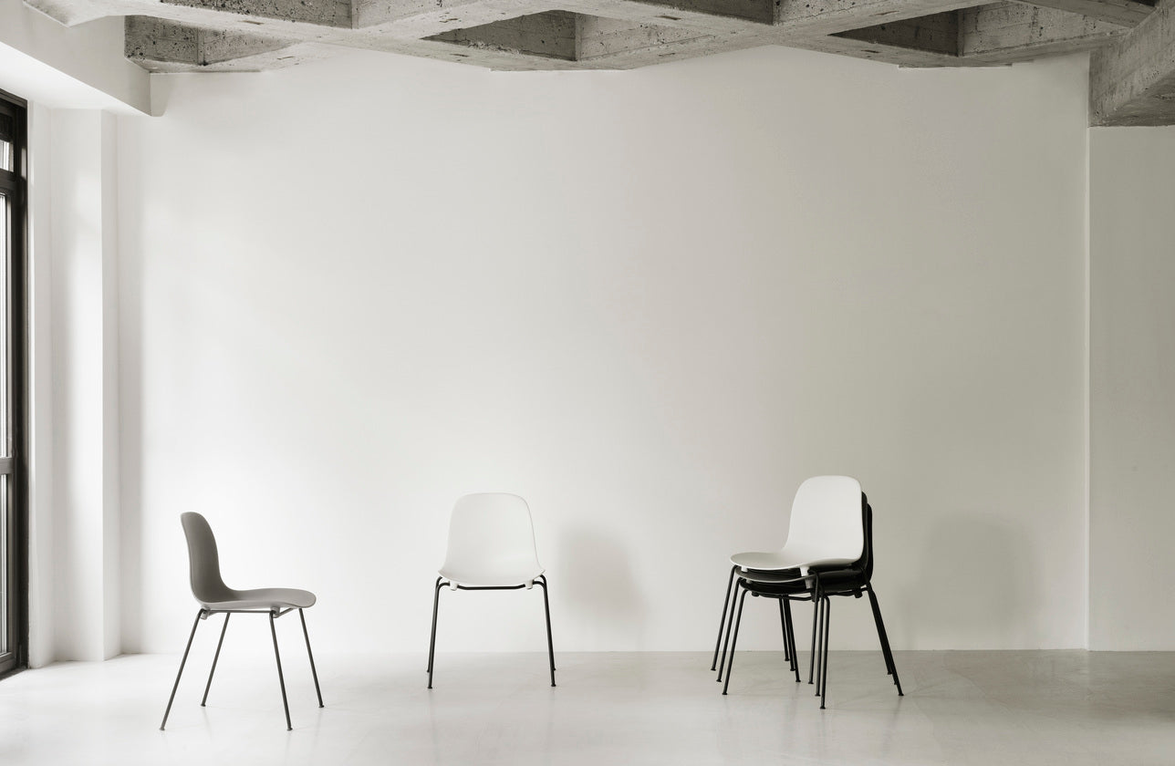 Red stacking chair with a black base