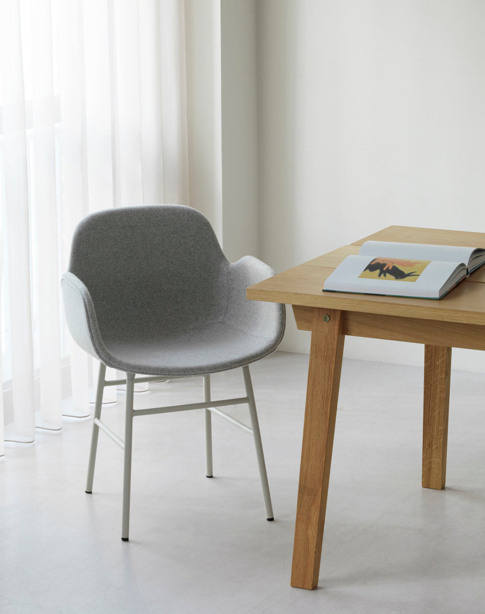 Upholstered chair with armrests of forms with a light gray base