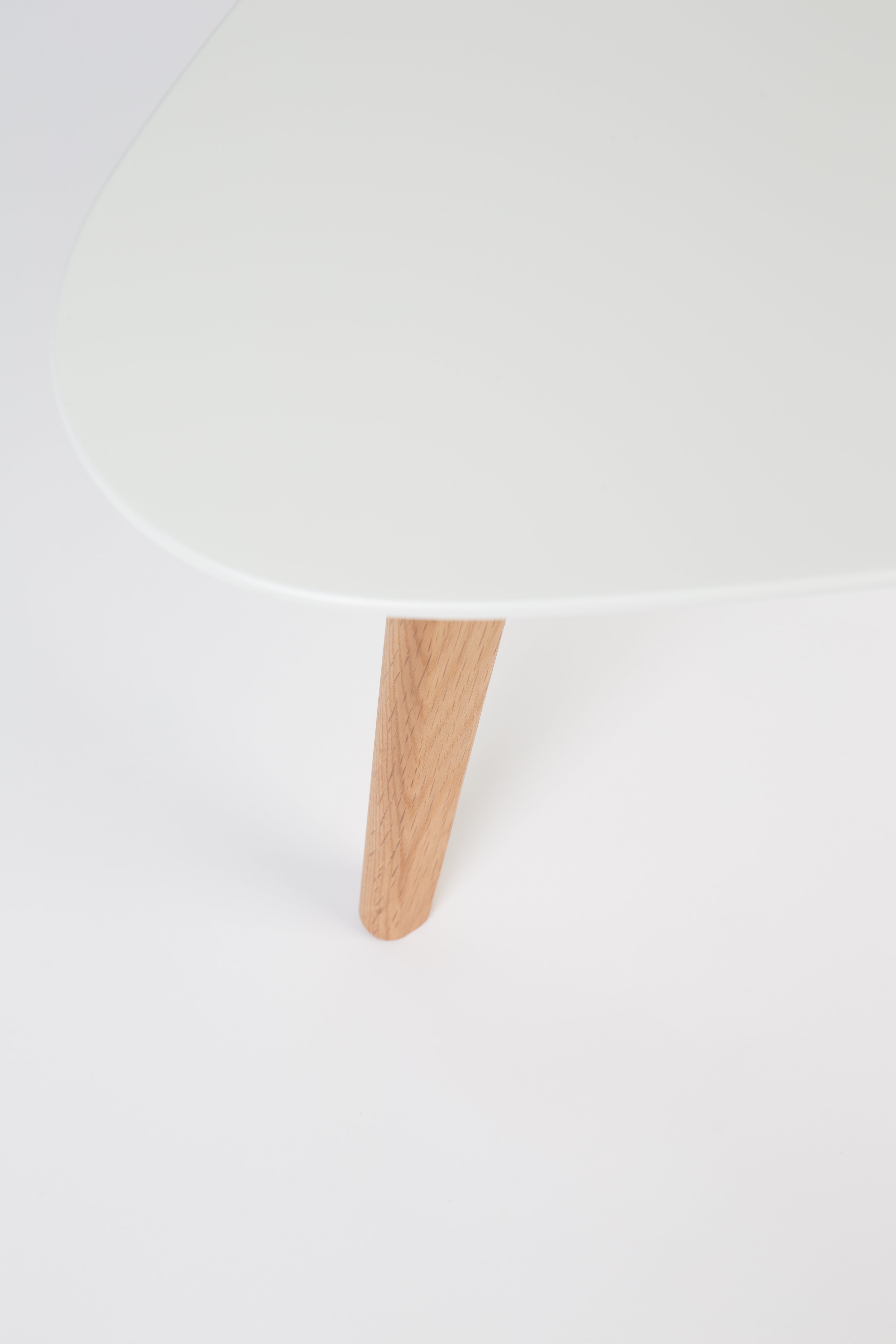 A set of white drop tables with a wooden base