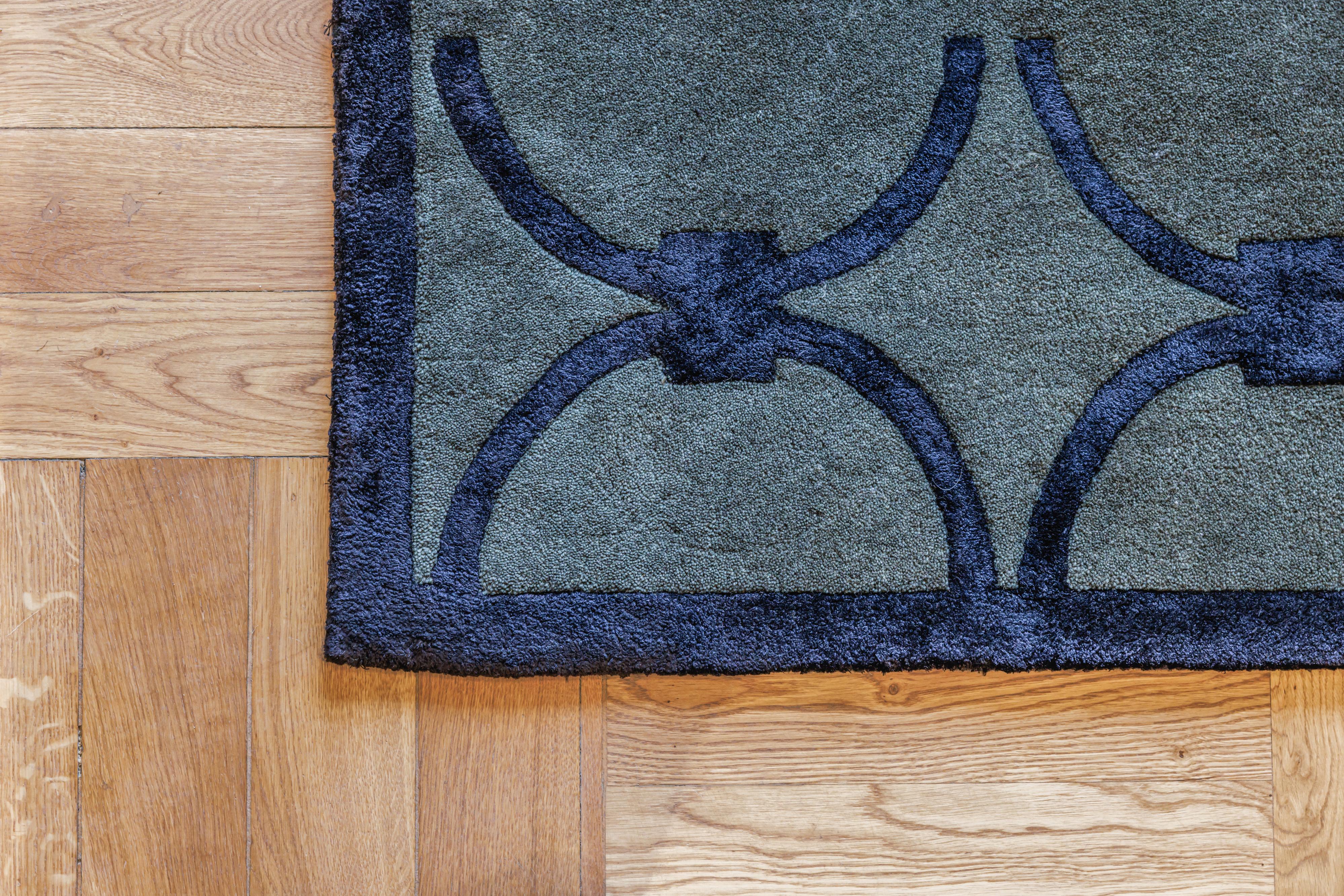 GLAM dark green rug with black geometric pattern