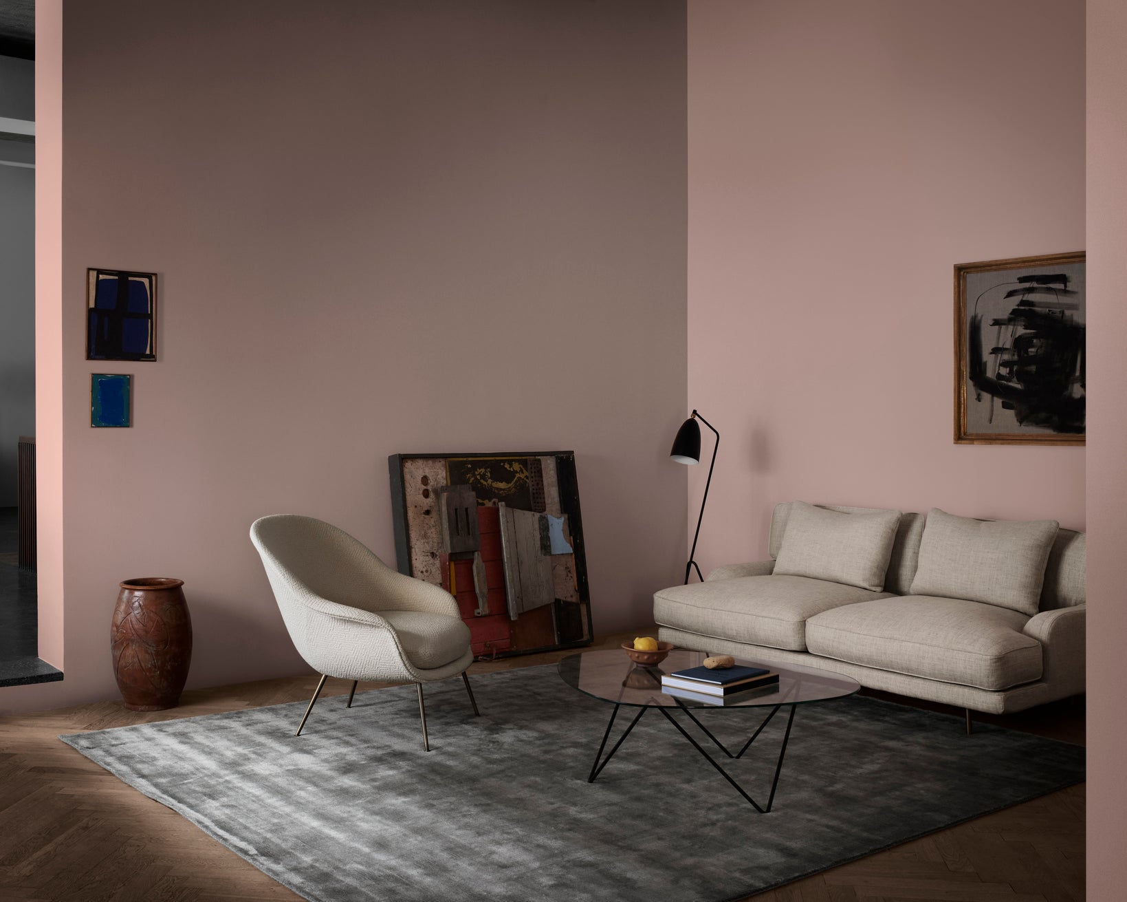 Upholstered BAT armchair with a gold base