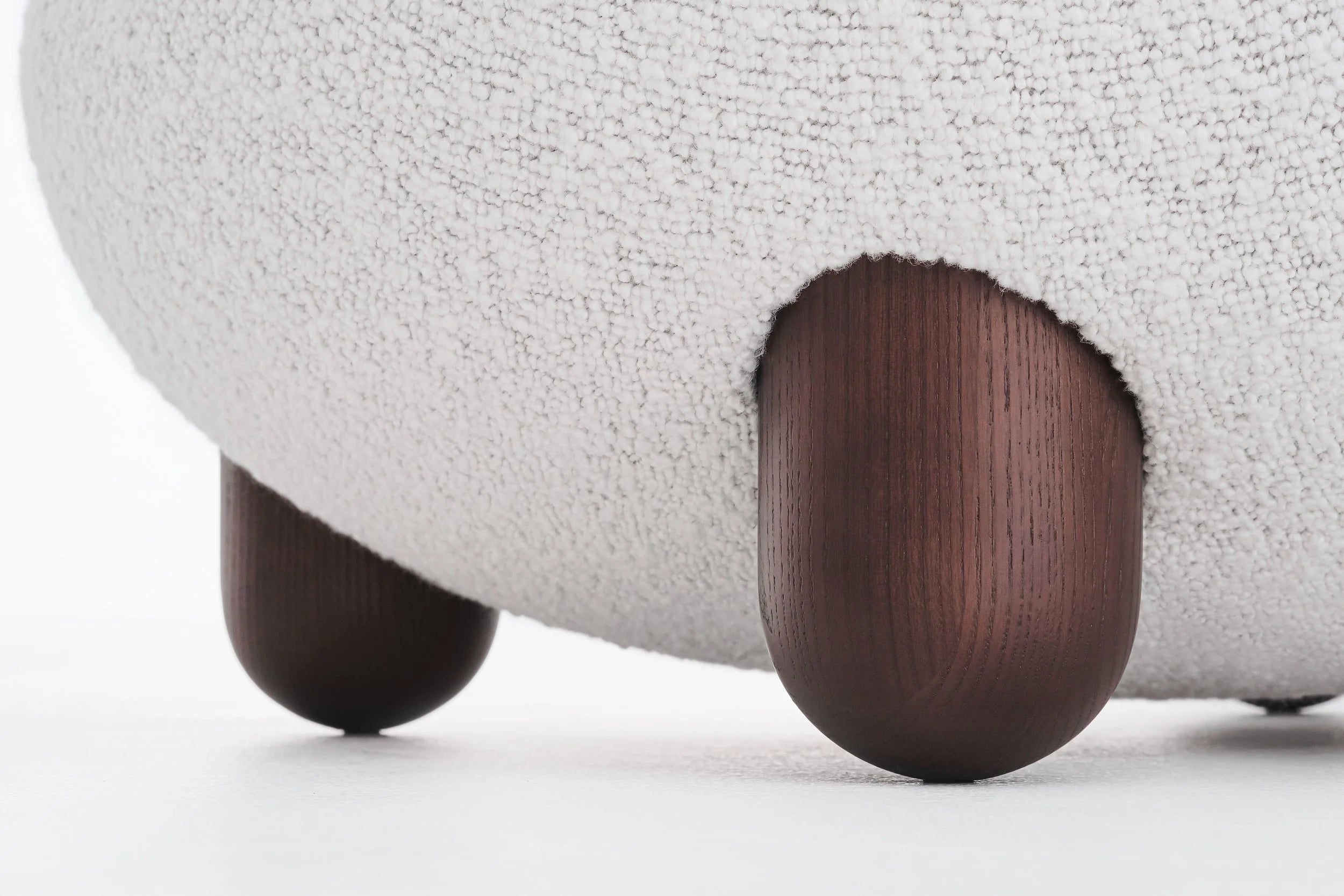 Upholstered pouf with wooden base
