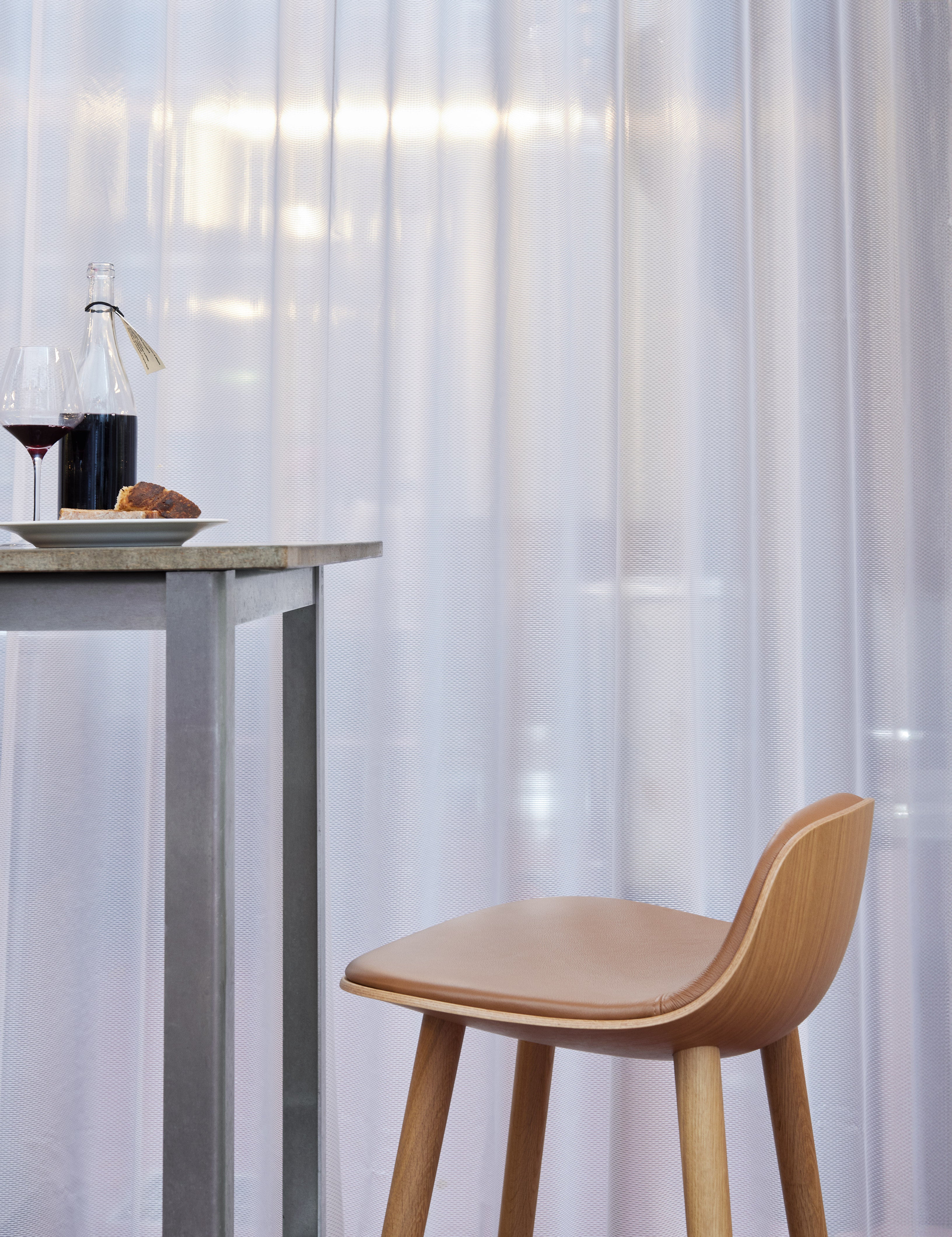 YUUGA stool in brown with a wooden base